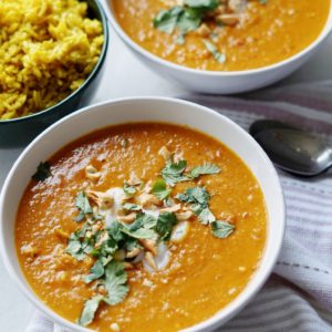 Bowl of coconut curry chicken soup with turmeric rice.