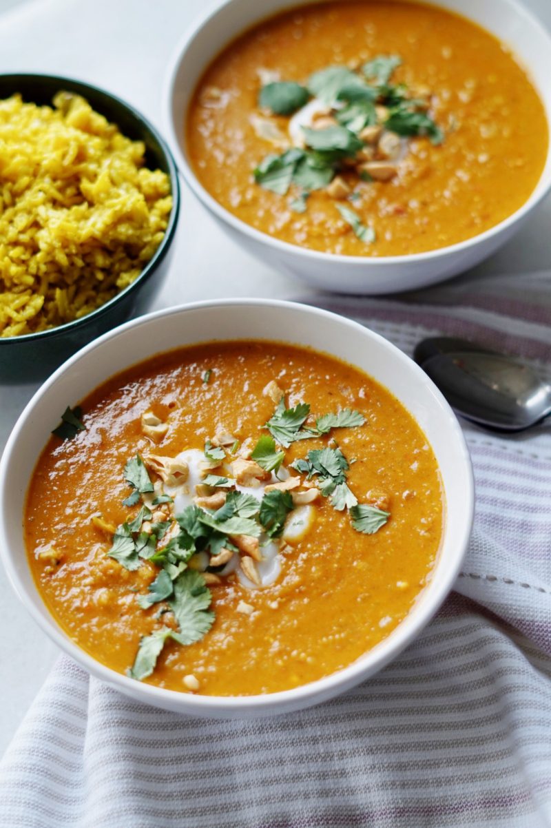 Bowl of coconut curry chicken soup with turmeric rice.