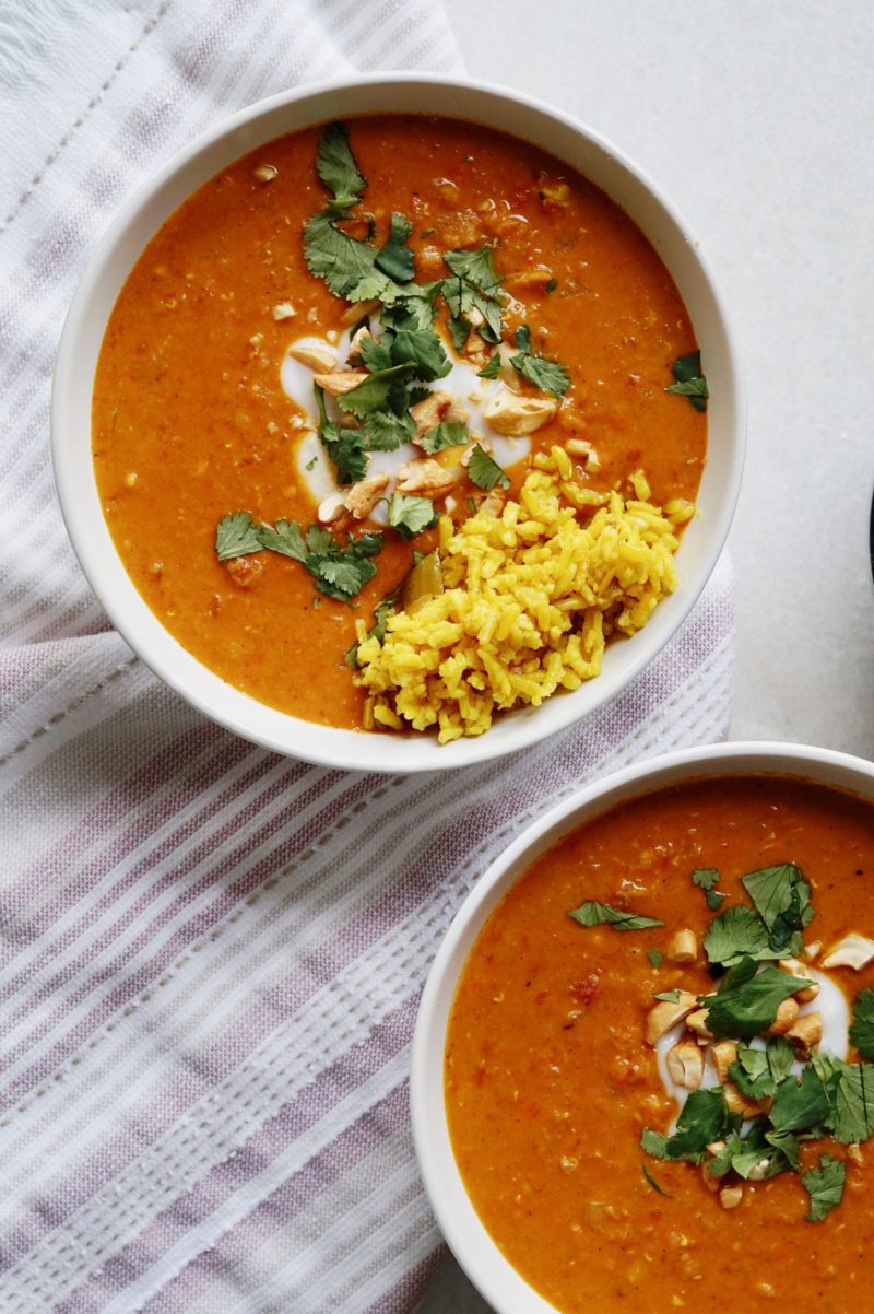 Bowl of coconut curry chicken soup with turmeric rice.